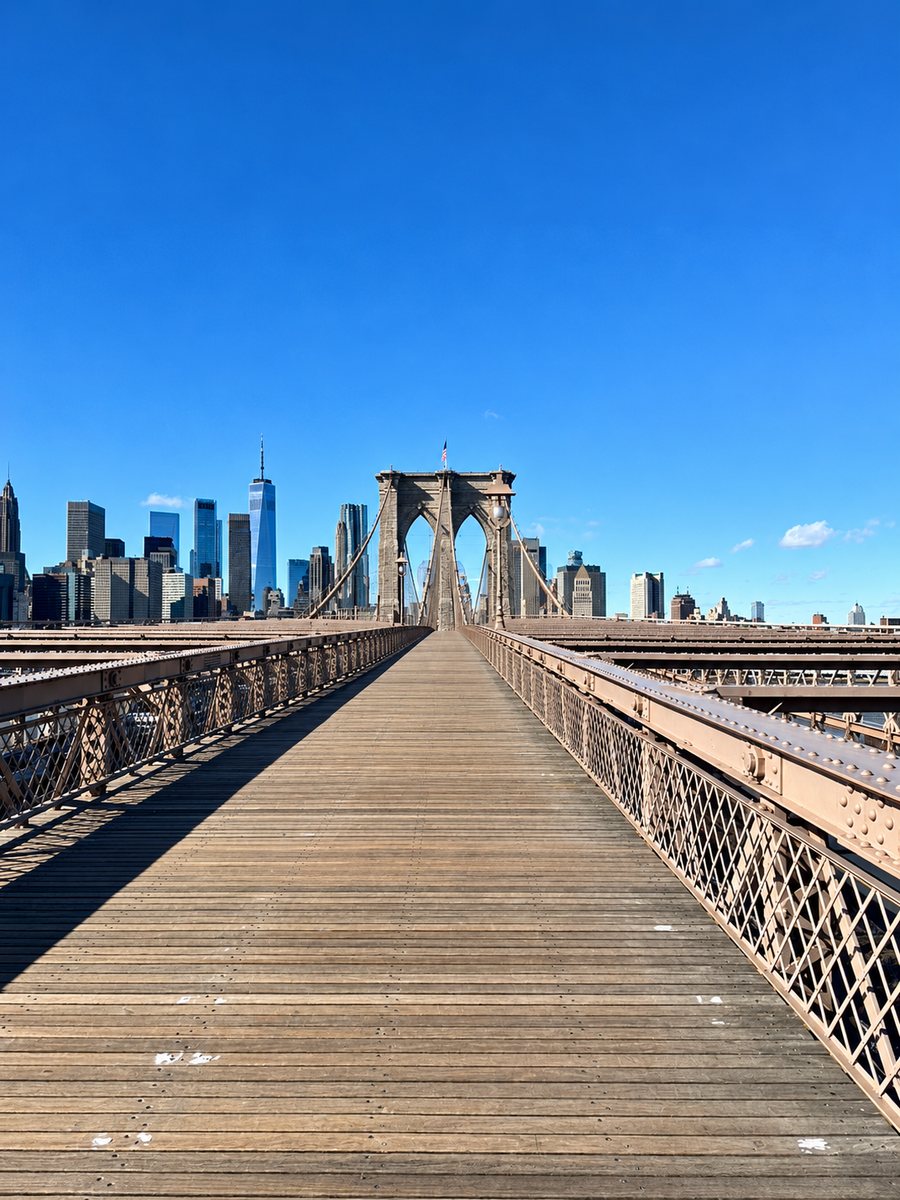 A bridge walkway leading toward a city skyline